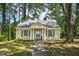 Charming yellow home with welcoming front porch and mature trees in a peaceful neighborhood at 940 Hill St, Rocky Mount, NC 27801