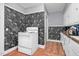 Compact kitchen with an electric stove, cabinets, and unique marble wallpaper at 940 Hill St, Rocky Mount, NC 27801