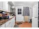 Functional kitchen featuring a sink, radiator, and checkered curtain at 940 Hill St, Rocky Mount, NC 27801