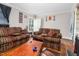 Spacious living room with hardwood floors, large sofas, and natural light at 940 Hill St, Rocky Mount, NC 27801