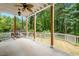 Enjoy the outdoors on this back deck with ceiling fan overlooking a wooded backyard at 9509 Greenfield Dr, Raleigh, NC 27615