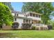 Exterior shot of the home with a sprawling backyard and mature trees at 9509 Greenfield Dr, Raleigh, NC 27615
