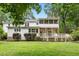 Wide angle shot of the lush backyard showing the exterior of the home at 9509 Greenfield Dr, Raleigh, NC 27615