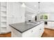 Open kitchen layout with a center island cooktop, custom cabinetry and connection to other rooms at 9509 Greenfield Dr, Raleigh, NC 27615