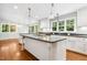 Spacious kitchen showcasing a center island with cooktop, ample counter space, and hardwood floors at 9509 Greenfield Dr, Raleigh, NC 27615