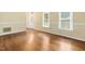 Inviting living room with hardwood floors, neutral wall color, and large windows for ample light at 9509 Greenfield Dr, Raleigh, NC 27615