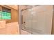 Bright bathroom featuring a glass enclosed tub and shower with white tile surround, and a view to the outdoors at 1 Davie Ln, Chapel Hill, NC 27514