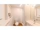 Bright bathroom with wood-look tile flooring, and a walk-in shower with white tile at 1 Davie Ln, Chapel Hill, NC 27514