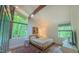 Bedroom with hardwood floors, many windows, and an exposed beam at 1 Davie Ln, Chapel Hill, NC 27514