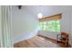 Cozy bedroom with wood floors, large windows overlooking lush greenery, and an armchair at 1 Davie Ln, Chapel Hill, NC 27514