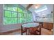 Bright dining area with oversized windows, a skylight, and a built-in wine refrigerator at 1 Davie Ln, Chapel Hill, NC 27514
