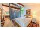 Main bedroom with an ensuite bathroom, hardwood floors, and an exposed beam at 1 Davie Ln, Chapel Hill, NC 27514