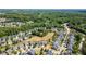 Wide aerial shot displaying a well-planned community with homes bordering wooded areas at 1004 Bridlemine Dr, Fuquay Varina, NC 27526