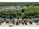 Wide aerial shot displays a neighborhood with green spaces, showcasing a tidy two-story home at 1004 Bridlemine Dr, Fuquay Varina, NC 27526