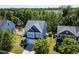Picturesque aerial view of a two-story home nestled within a vibrant, green residential neighborhood at 1004 Bridlemine Dr, Fuquay Varina, NC 27526