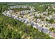 Bird's eye perspective of homes nestled among mature trees in a peaceful neighborhood at 1004 Bridlemine Dr, Fuquay Varina, NC 27526