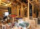 Unfinished attic space with exposed wood beams and a window, offering potential for customization at 1004 Bridlemine Dr, Fuquay Varina, NC 27526