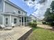 Backyard patio with a screened porch and additional seating area surrounded by greenery at 1004 Bridlemine Dr, Fuquay Varina, NC 27526