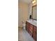 Bathroom boasts a single sink vanity with granite countertop and wood cabinets at 1004 Bridlemine Dr, Fuquay Varina, NC 27526