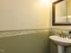 Powder room showcasing a pedestal sink and decorative mirror at 1004 Bridlemine Dr, Fuquay Varina, NC 27526