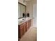 Bathroom features a double sink vanity, tile flooring, and wood cabinets at 1004 Bridlemine Dr, Fuquay Varina, NC 27526