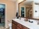 Bathroom featuring double sink vanity, toilet, walk-in closet, and glass door shower at 1004 Bridlemine Dr, Fuquay Varina, NC 27526