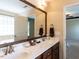 Bathroom showcasing a double sink vanity, granite countertops, and wood cabinets at 1004 Bridlemine Dr, Fuquay Varina, NC 27526