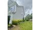 Side view of a two-story home with light gray siding and manicured landscaping at 1004 Bridlemine Dr, Fuquay Varina, NC 27526