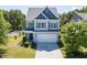 Charming two-story home featuring a neatly landscaped front yard and a two-car garage at 1004 Bridlemine Dr, Fuquay Varina, NC 27526