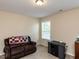 Inviting living room with plush seating, soft carpet, and a bright window at 1004 Bridlemine Dr, Fuquay Varina, NC 27526