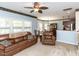 Comfortable living room with a ceiling fan, ample natural light, and a warm atmosphere at 1004 Bridlemine Dr, Fuquay Varina, NC 27526