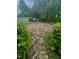 Charming stone patio surrounded by lush greenery, offering a peaceful outdoor space at 1004 Bridlemine Dr, Fuquay Varina, NC 27526