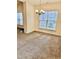 Dining area with large windows, carpeted floors, and a modern chandelier at 1017 Red Hat Ln, Durham, NC 27713