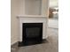 Inviting fireplace with white mantel and black accents for a cozy living space at 1017 Red Hat Ln, Durham, NC 27713
