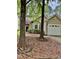 Charming home featuring a bay window and an attached one-car garage with trees at 1017 Red Hat Ln, Durham, NC 27713