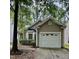 Home exterior with one car garage, bay window, neutral paint color and mature landscaping at 1017 Red Hat Ln, Durham, NC 27713