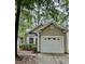 Home exterior with one car garage, bay window, neutral paint color and mature landscaping at 1017 Red Hat Ln, Durham, NC 27713