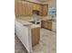 Well-lit kitchen features linoleum floors, countertops, white appliances, and wooden cabinets at 1017 Red Hat Ln, Durham, NC 27713