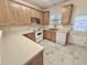 Kitchen with wooden cabinets, linoleum floors, countertops, and white appliances at 1017 Red Hat Ln, Durham, NC 27713