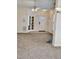 Bright, carpeted living room with ceiling fan and an entry door at 1017 Red Hat Ln, Durham, NC 27713
