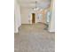Spacious, carpeted living room with ceiling fan and entry door to the home at 1017 Red Hat Ln, Durham, NC 27713