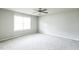 Neutral bedroom with ceiling fan, carpet floors, and large window for plenty of natural light at 103 Hampshire Pl, Kenly, NC 27542