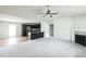 Spacious living room with a ceiling fan, fireplace, and an open view of the kitchen at 103 Hampshire Pl, Kenly, NC 27542