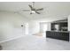 Open concept living room featuring a ceiling fan and hardwood floors adjacent to the kitchen at 103 Hampshire Pl, Kenly, NC 27542
