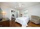 Comfortable bedroom with ceiling fan, wood floors, and adjoining sunroom at 106 E Club Blvd, Durham, NC 27704