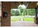 Inviting front porch with brick flooring and an arched entryway offering a street view at 106 E Club Blvd, Durham, NC 27704