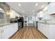Updated kitchen boasting white cabinets, granite countertops, and stainless steel appliances at 106 E Club Blvd, Durham, NC 27704