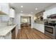 Modern kitchen featuring stainless steel appliances, granite countertops, and stylish hardwood floors at 106 E Club Blvd, Durham, NC 27704