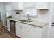 Bright kitchen with stainless steel appliances, granite counters, and white cabinetry at 106 E Club Blvd, Durham, NC 27704