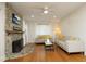 Cozy living room featuring a stone fireplace, hardwood floors, and ample natural light at 106 E Club Blvd, Durham, NC 27704